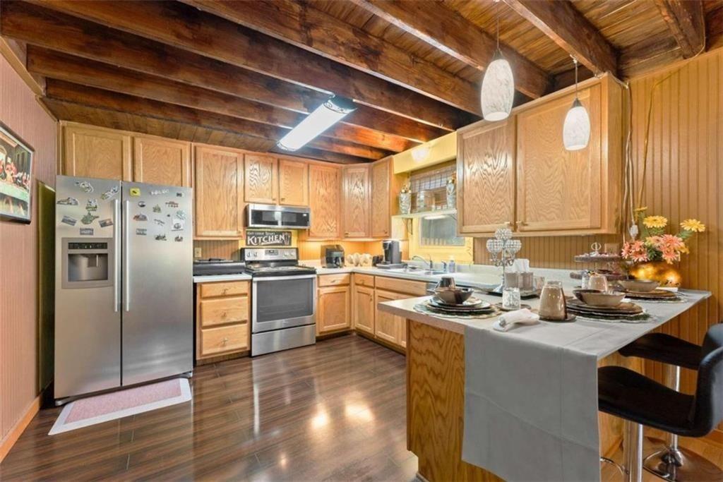 459 Gold Ridge Road Dahlonega, GA 30533 - Photo 13 of 47 a kitchen with refrigerator cabinets and wooden floor