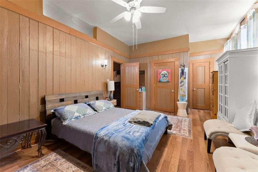 459 Gold Ridge Road Dahlonega, GA 30533 - Photo 23 of 47 a bedroom with bed and a chandelier