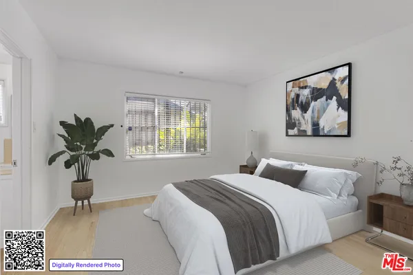 a bedroom with a bed and a painting on the wall