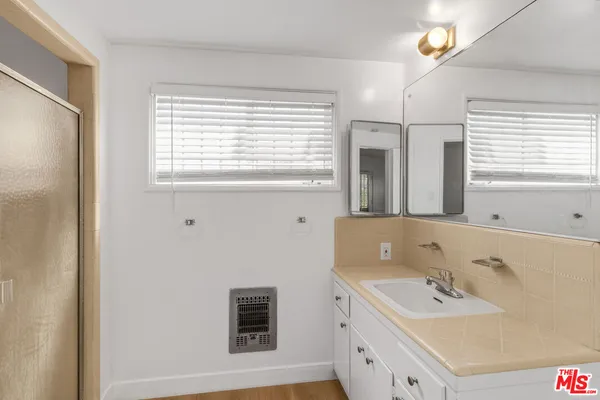 a bathroom with a sink a vanity and a mirror