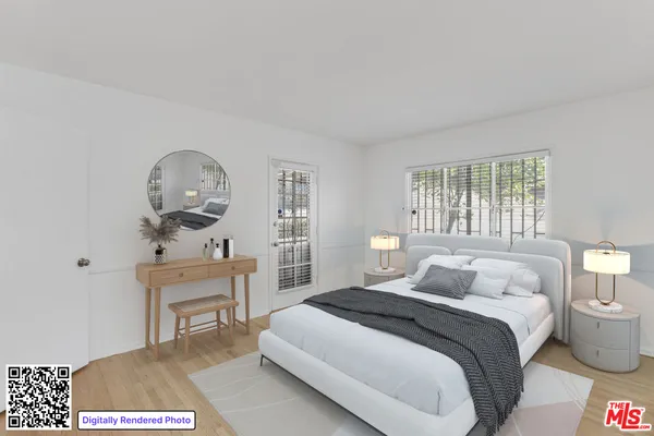 a bedroom with a bed a mirror and a window