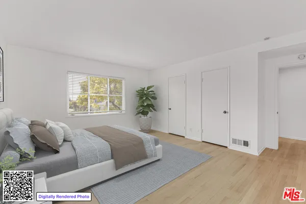 a spacious bedroom with a bed and a window