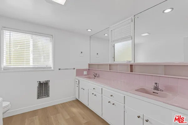 a spacious bathroom with a granite countertop sink mirror and a toilet