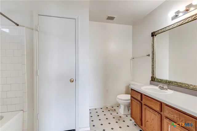 a bathroom with a sink a toilet a shower and a mirror
