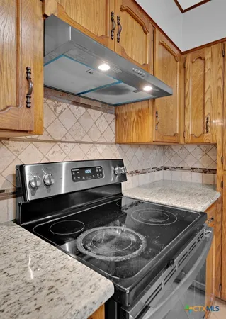 a stove top oven sitting inside of a kitchen