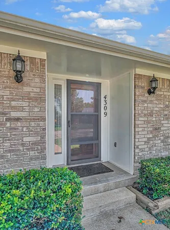 a front view of a house with a glass door