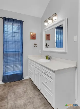 a bathroom with a sink double vanity and a mirror