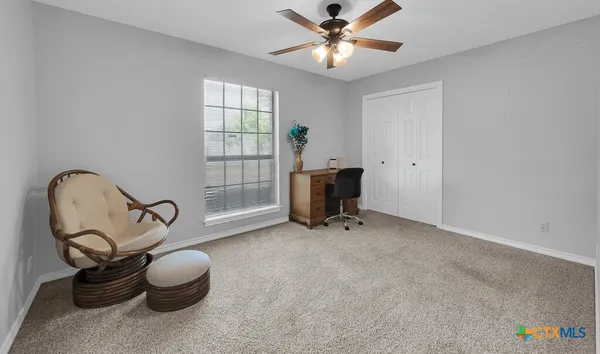 a view of room with workspace and windows