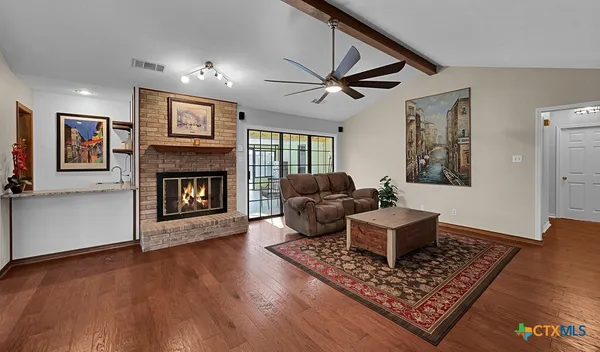 a living room with furniture and a fireplace