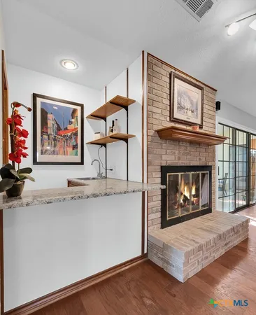 a living room with furniture a fireplace and a flat screen tv