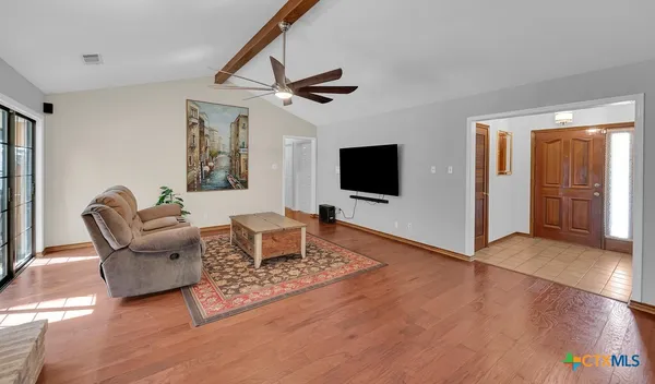 a living room with furniture and a flat screen tv