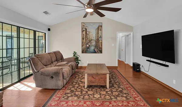 a living room with furniture and a flat screen tv
