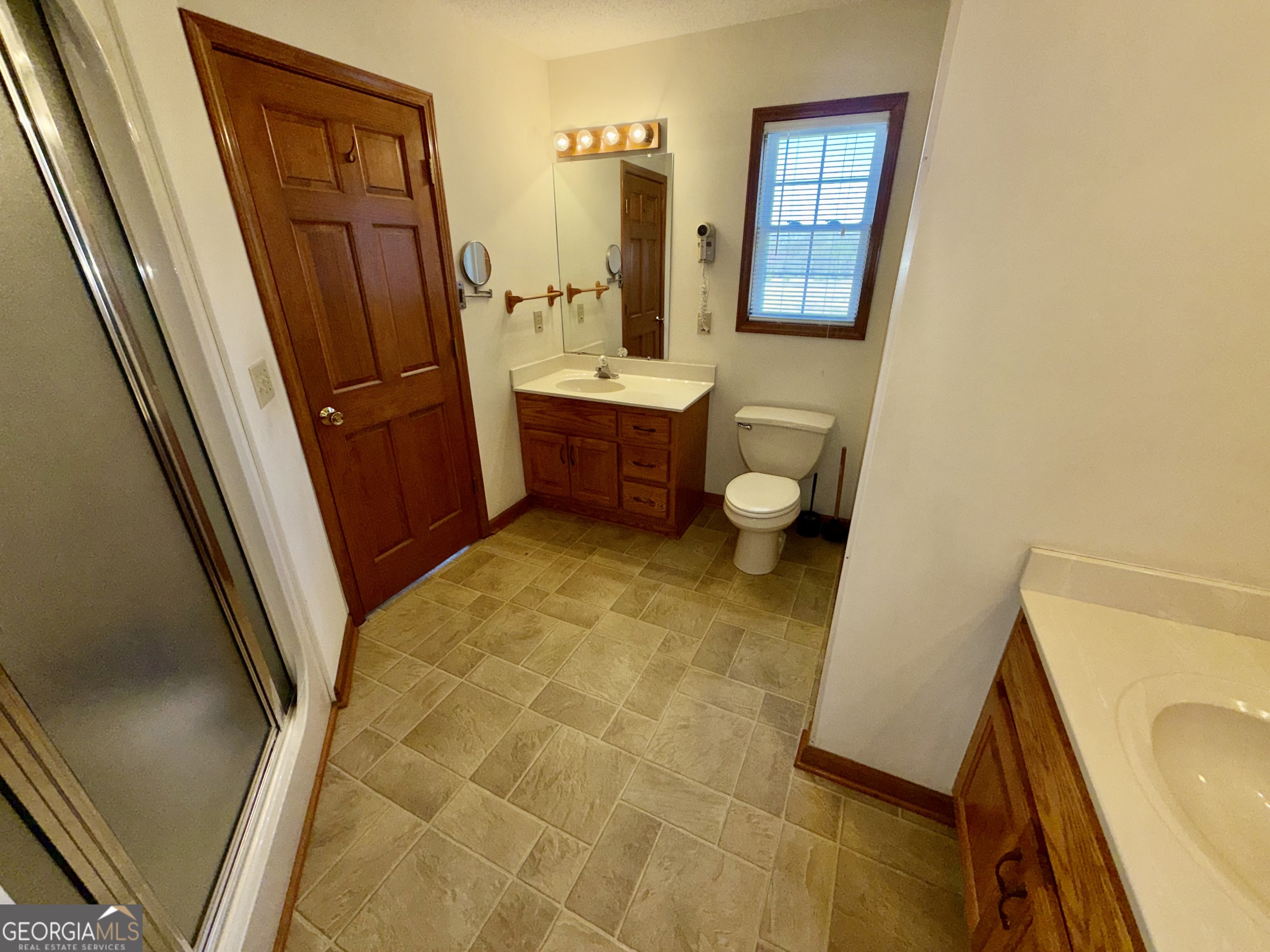 494 Broad Street Bowman, GA 30624 - Photo 33 of 65 a bathroom with a sink a mirror and a bathtub