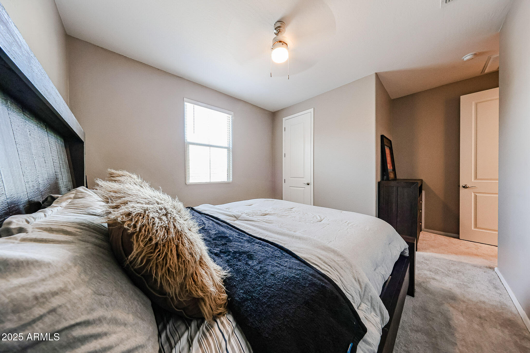 3907 South 75th Drive Phoenix, AZ 85043 - Photo 14 of 49 a bedroom with a bed and a chandelier
