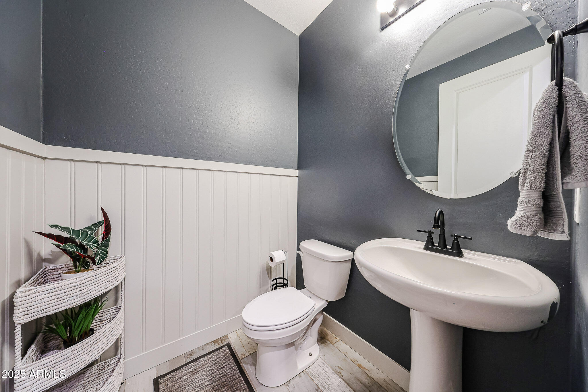 3907 South 75th Drive Phoenix, AZ 85043 - Photo 20 of 49 a bathroom with a toilet sink and mirror
