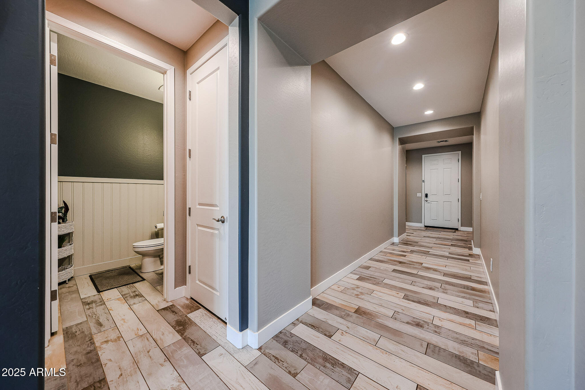 3907 South 75th Drive Phoenix, AZ 85043 - Photo 21 of 49 a view of a hallway with toilet and a bathroom