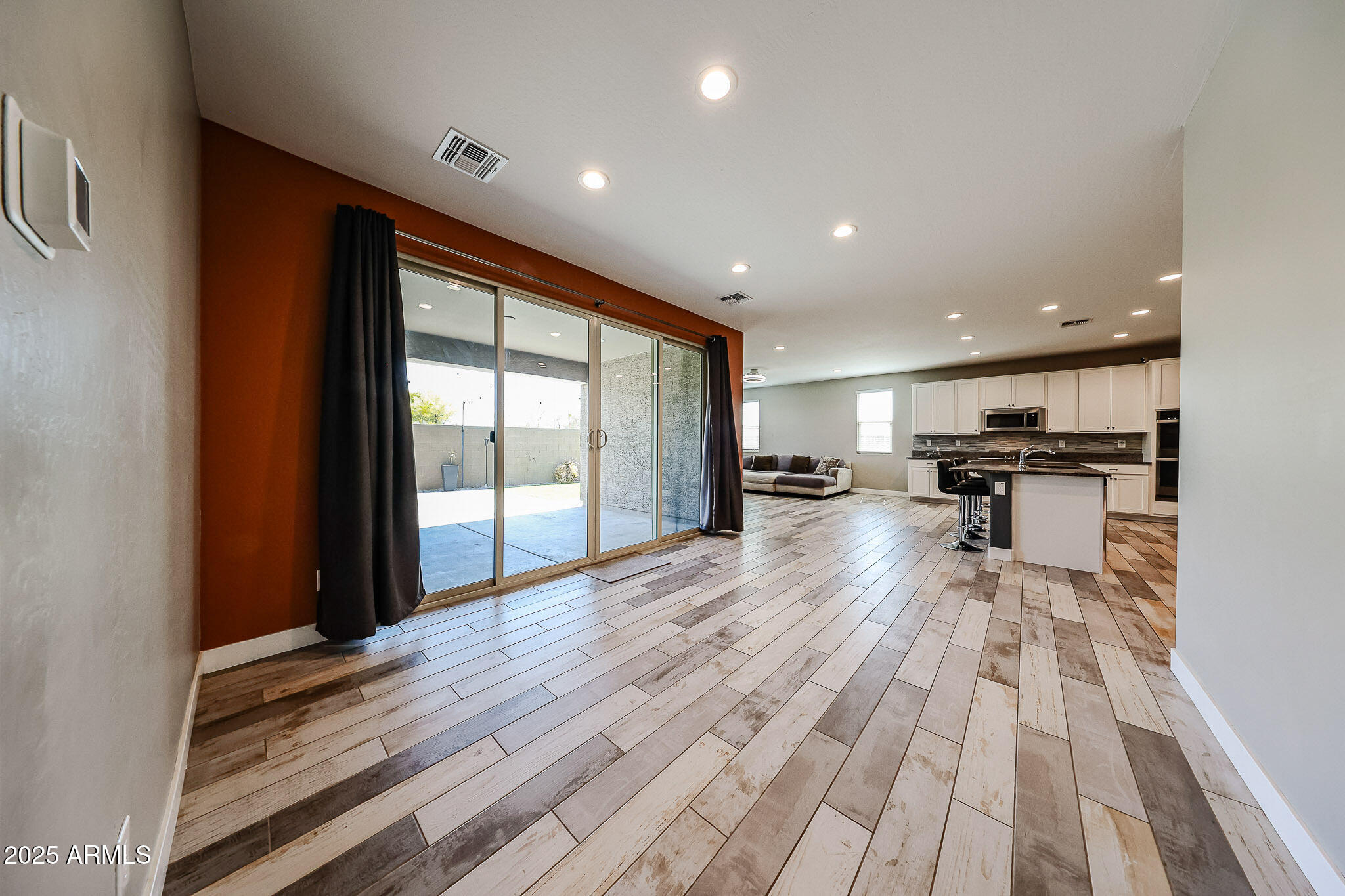3907 South 75th Drive Phoenix, AZ 85043 - Photo 23 of 49 a view of a living room a stove and wooden floor