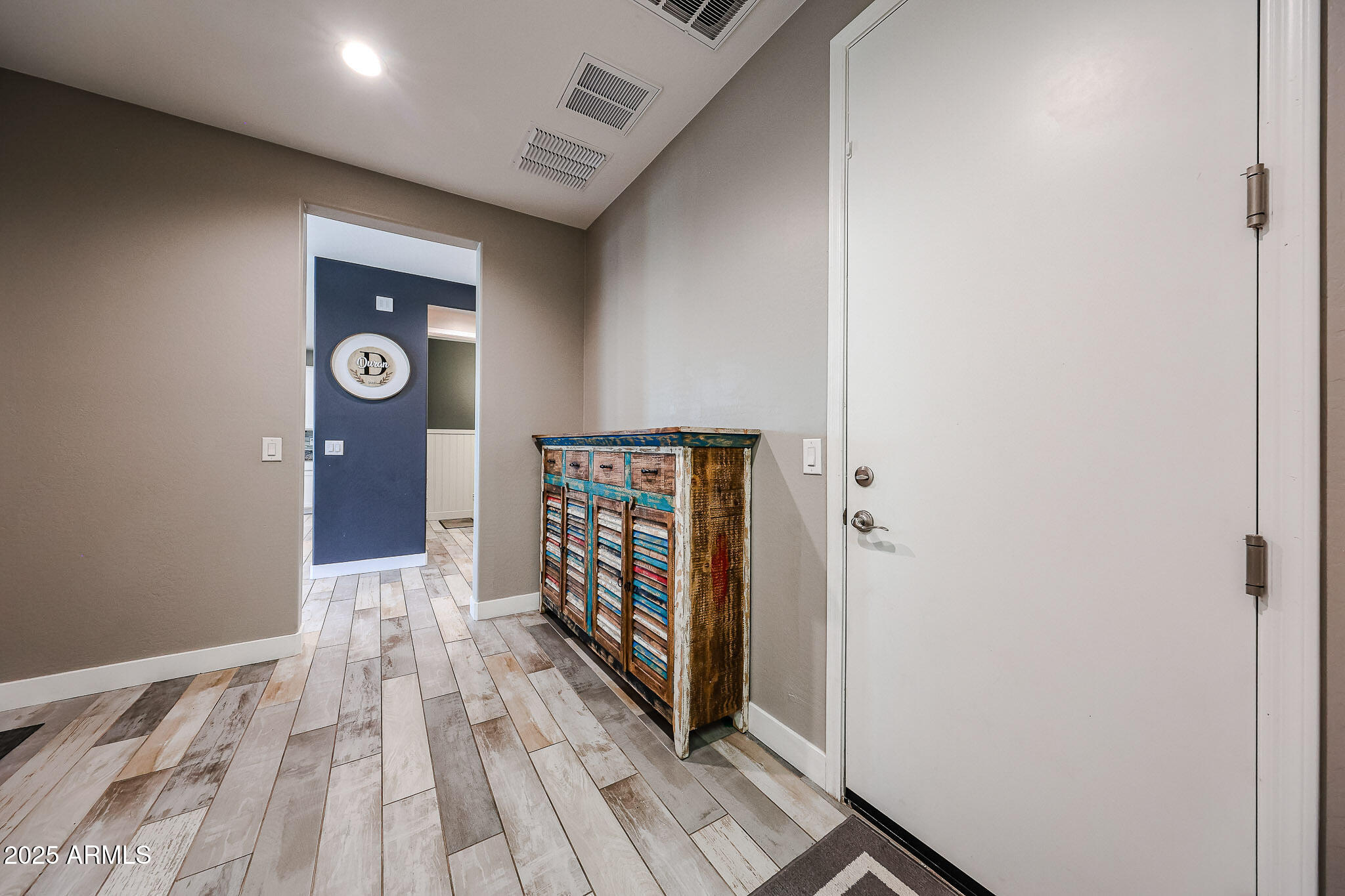 3907 South 75th Drive Phoenix, AZ 85043 - Photo 31 of 49 a view of entryway with wooden floor