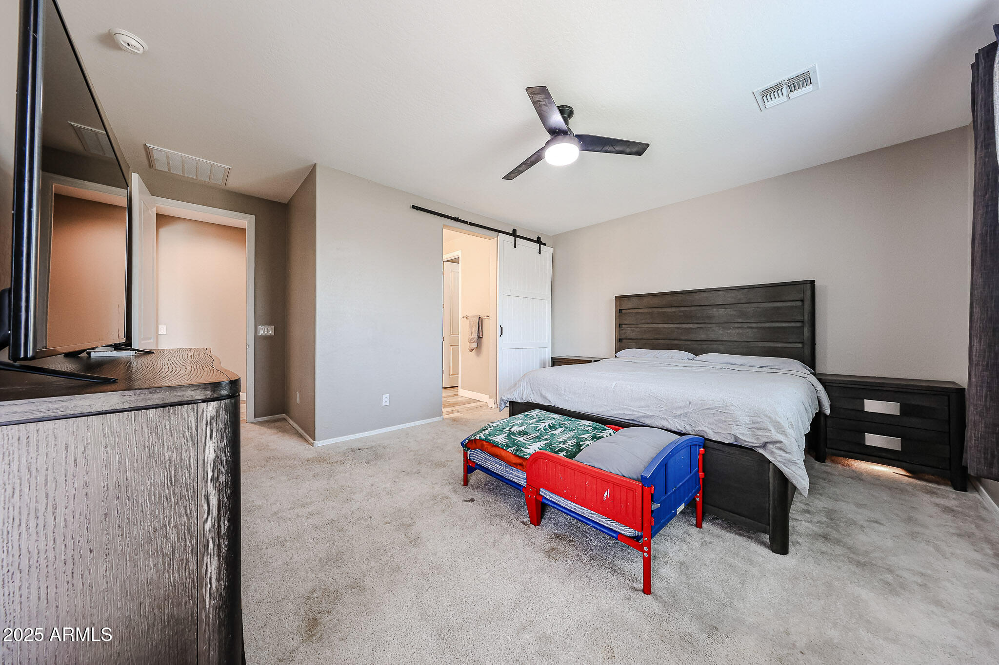 3907 South 75th Drive Phoenix, AZ 85043 - Photo 35 of 49 a bedroom with a bed and wooden floor