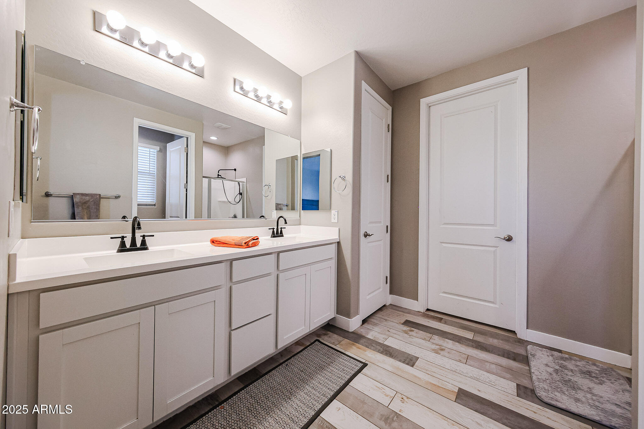 3907 South 75th Drive Phoenix, AZ 85043 - Photo 36 of 49 a spacious bathroom with a double vanity sink and mirror