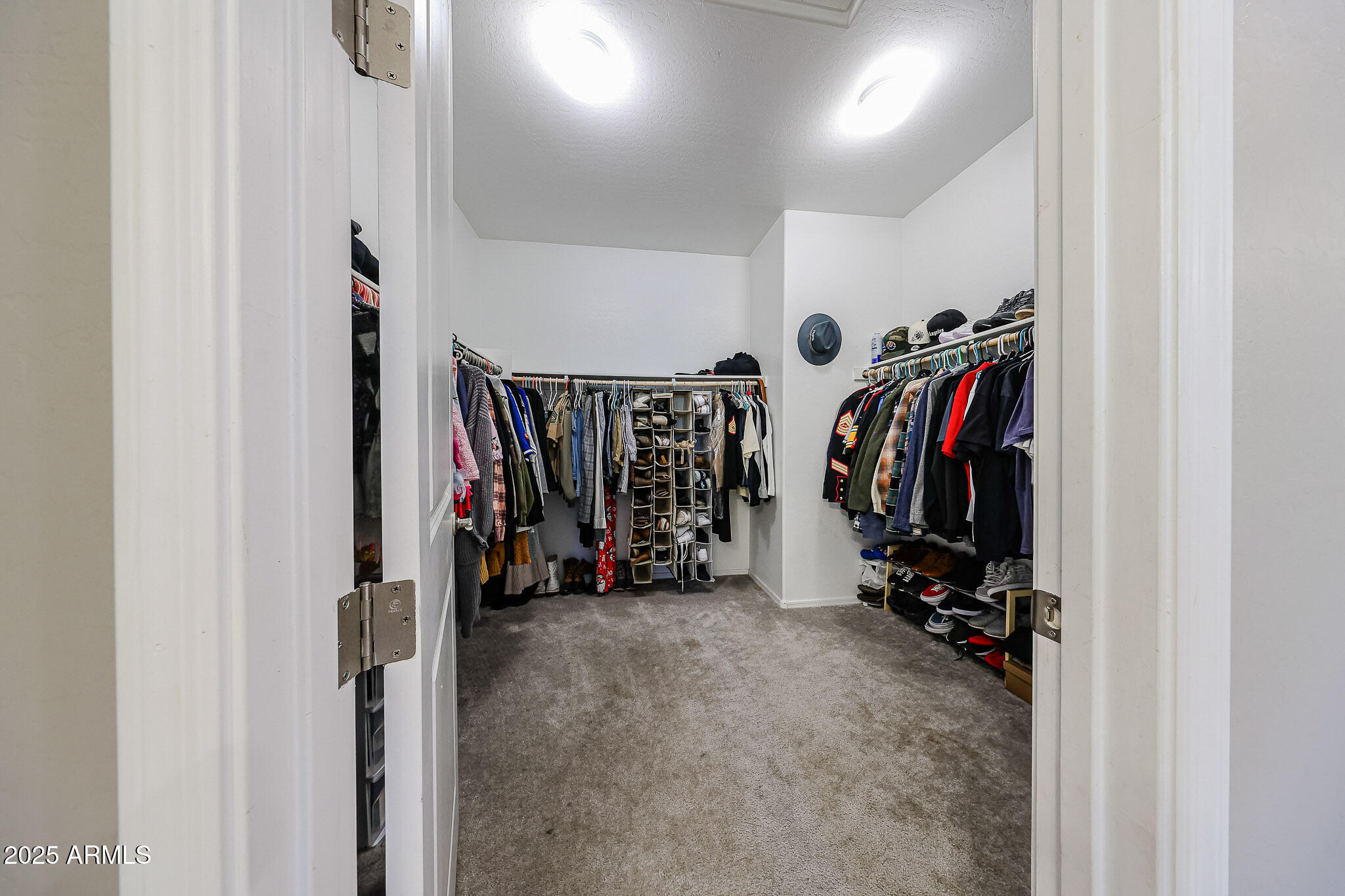 3907 South 75th Drive Phoenix, AZ 85043 - Photo 38 of 49 a view of walk in closet with clothes