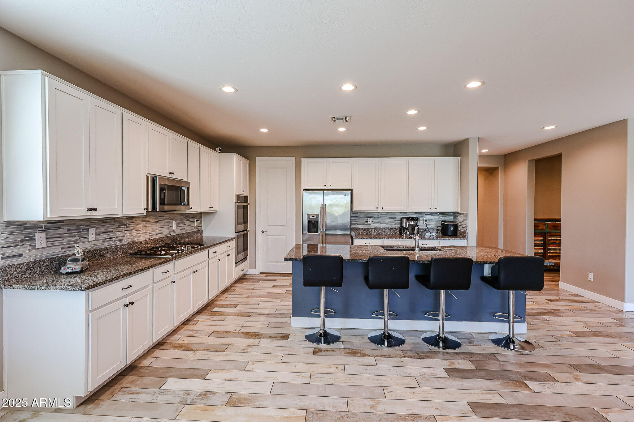 3907 South 75th Drive Phoenix, AZ 85043 - Photo 3 of 49 a kitchen with granite countertop counter top space appliances and cabinets