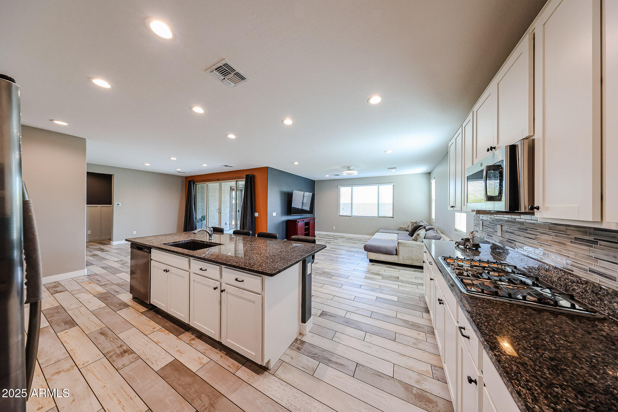 3907 South 75th Drive Phoenix, AZ 85043 - Photo 4 of 49 a kitchen with stainless steel appliances granite countertop a stove and a sink