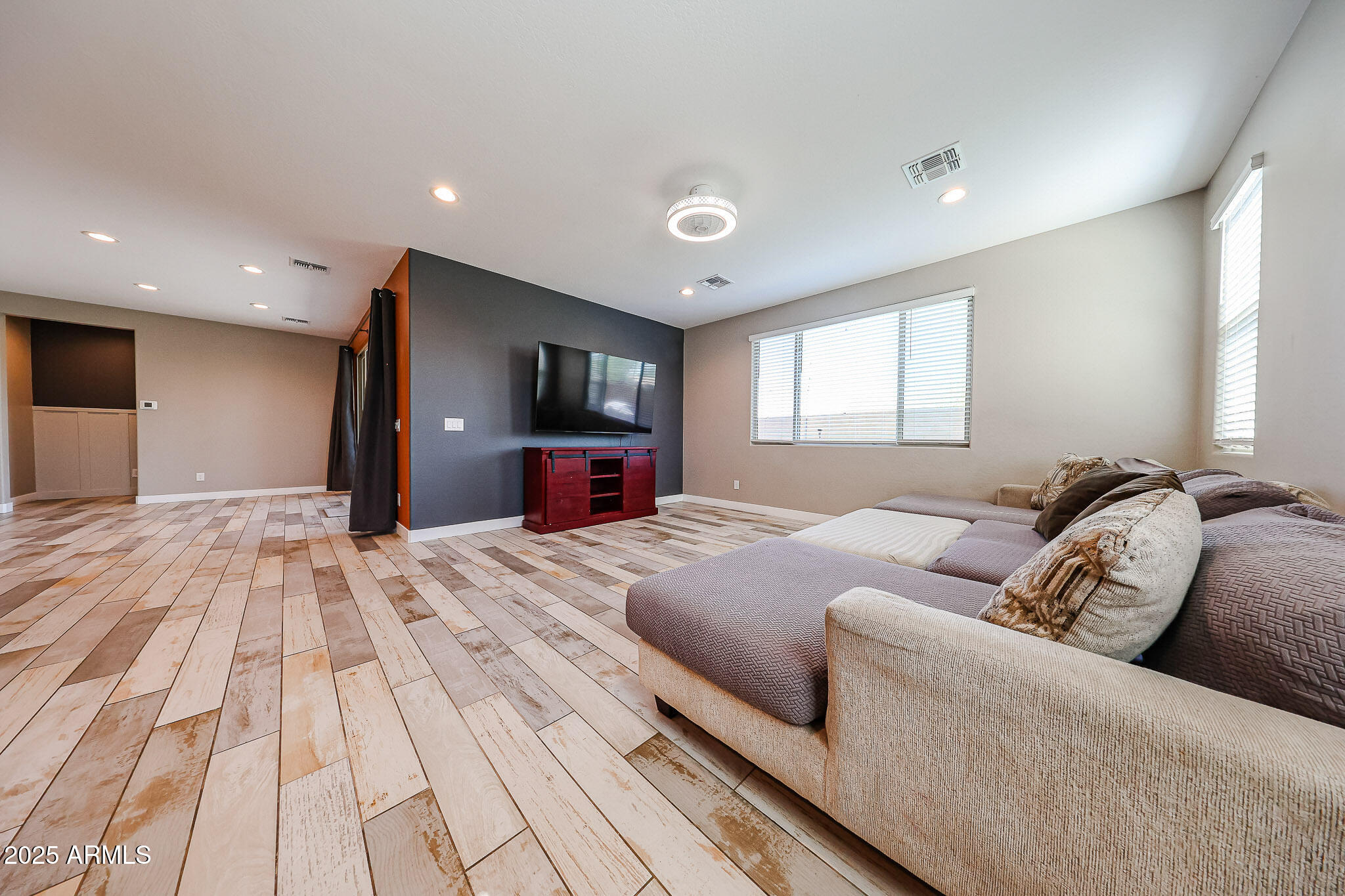 3907 South 75th Drive Phoenix, AZ 85043 - Photo 5 of 49 a bedroom with a large bed and a flat screen tv