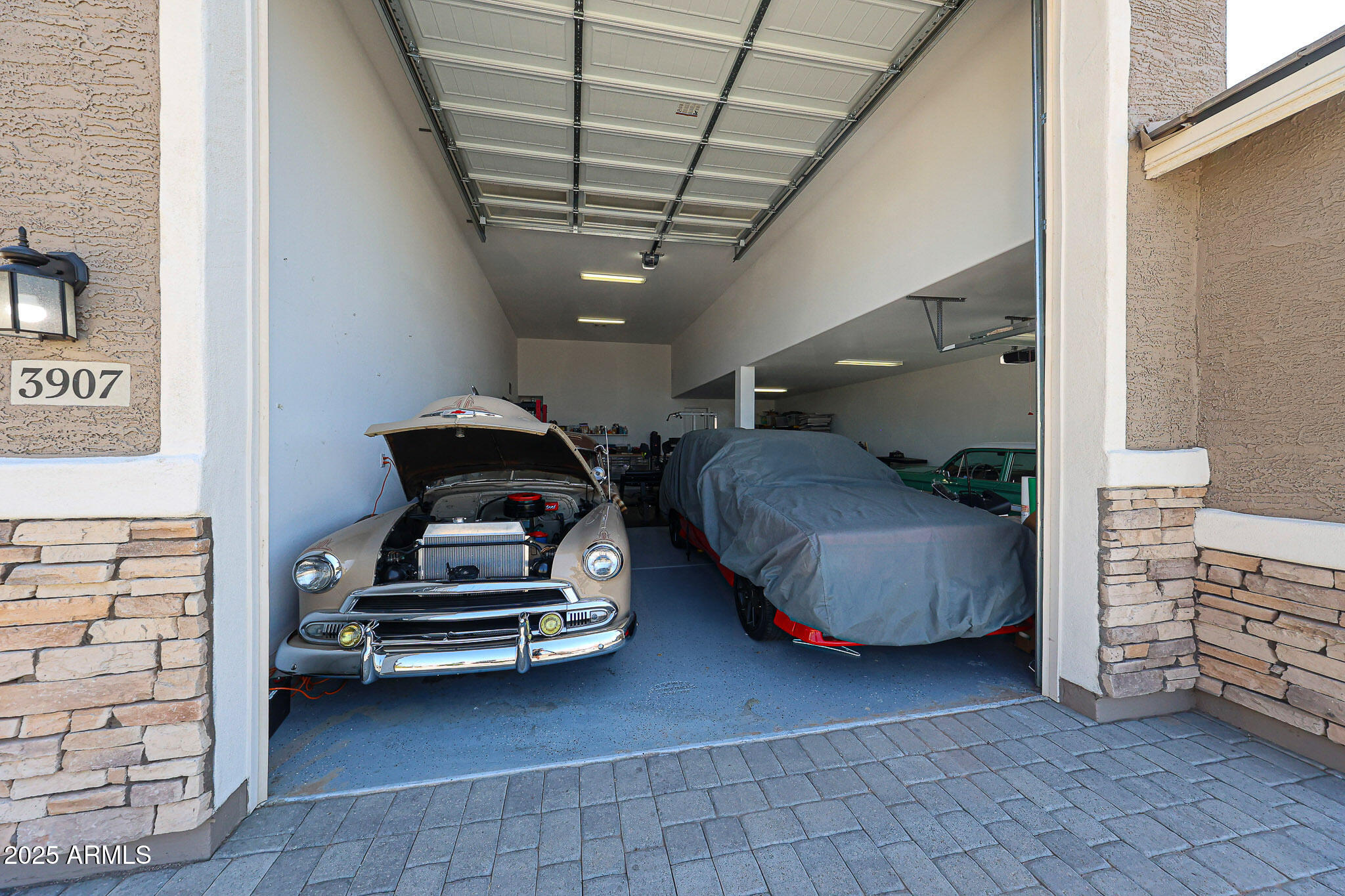 3907 South 75th Drive Phoenix, AZ 85043 - Photo 9 of 49 a bedroom with bed and a chandelier