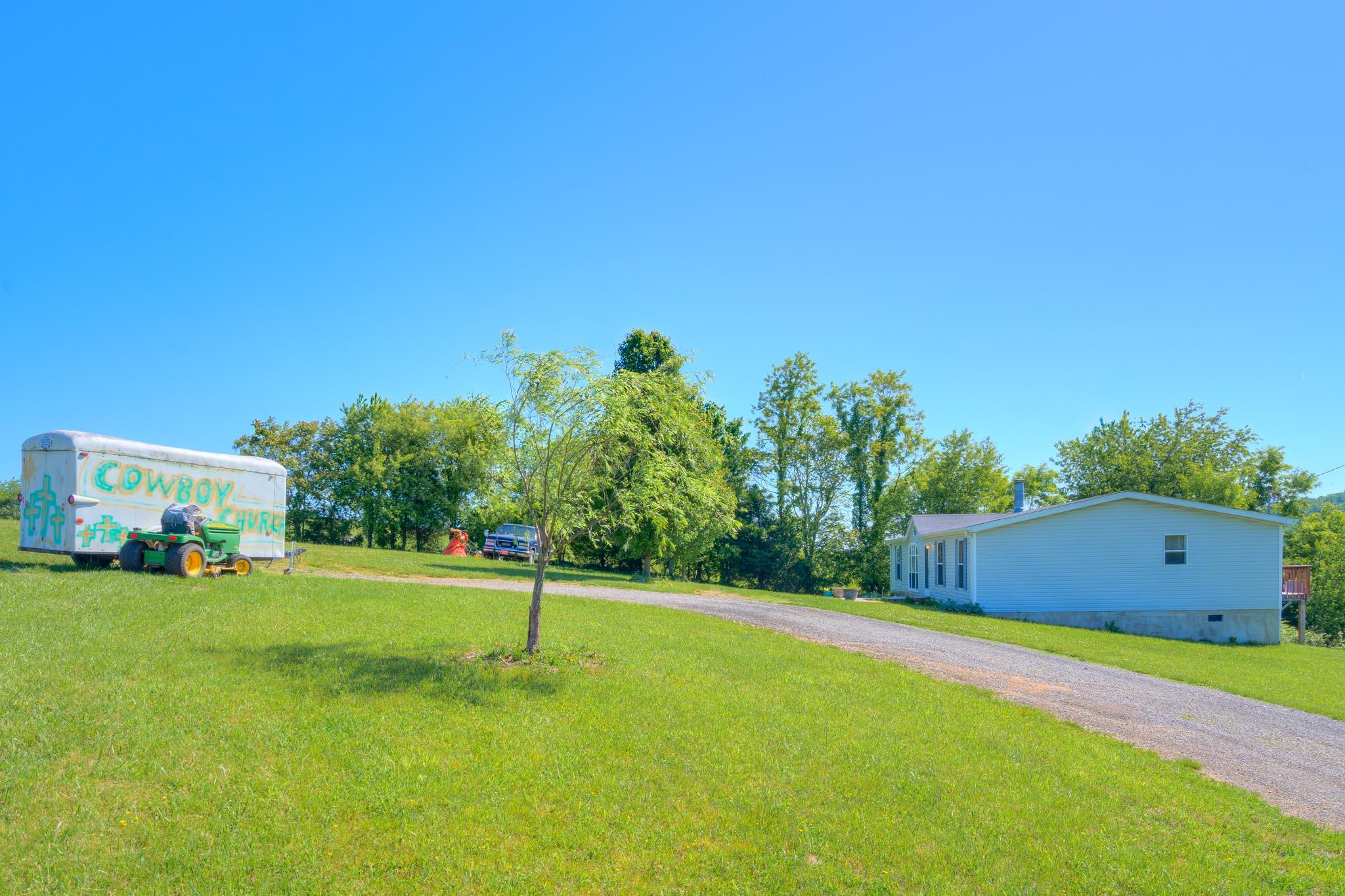 3240 Dallas Freeman Road Hiwassee, VA 24347 - Photo 22 of 42 a backyard of a house with lots of green space and trees