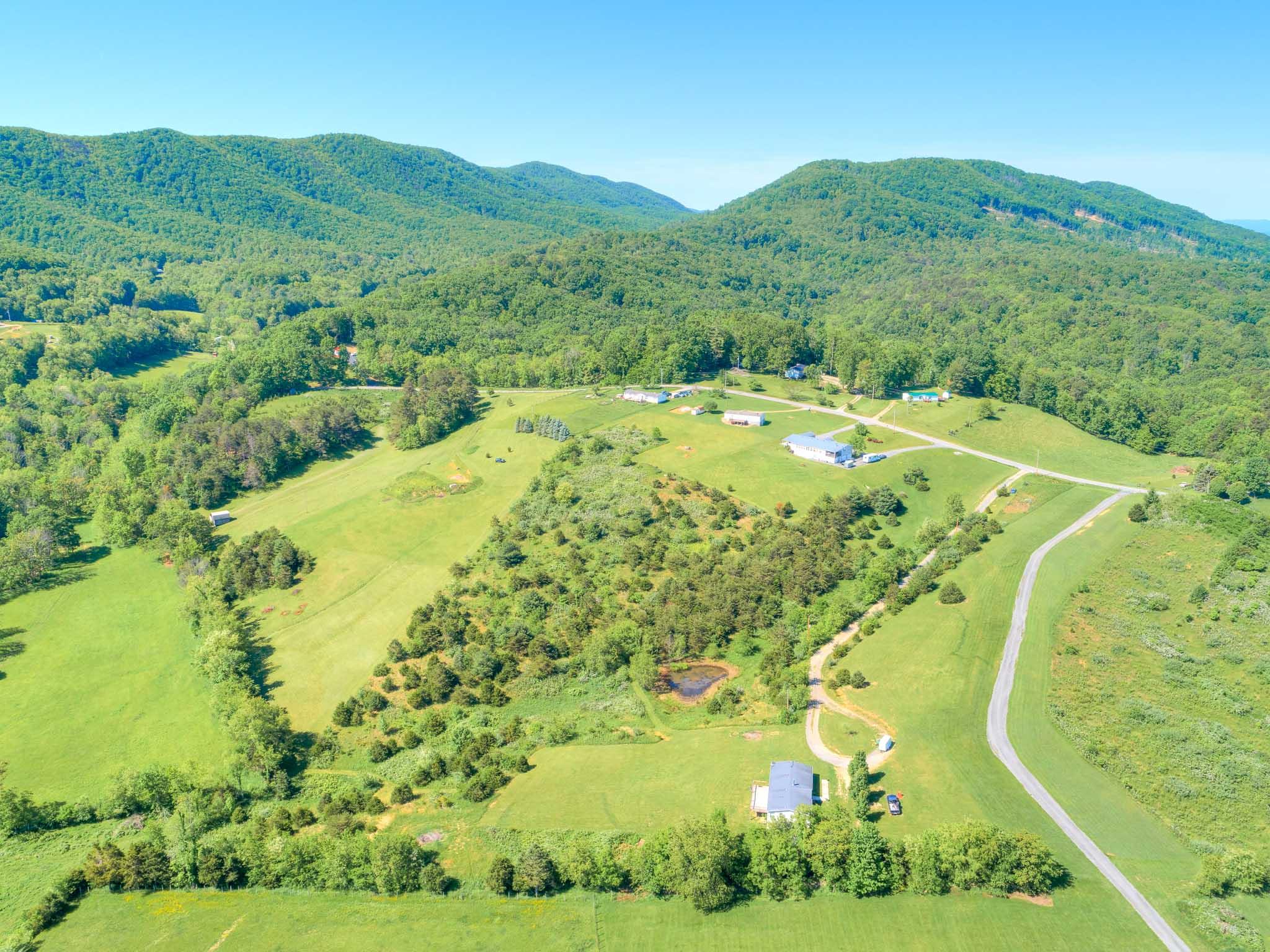 3240 Dallas Freeman Road Hiwassee, VA 24347 - Photo 40 of 42 a view of a lush green hillside and a houses