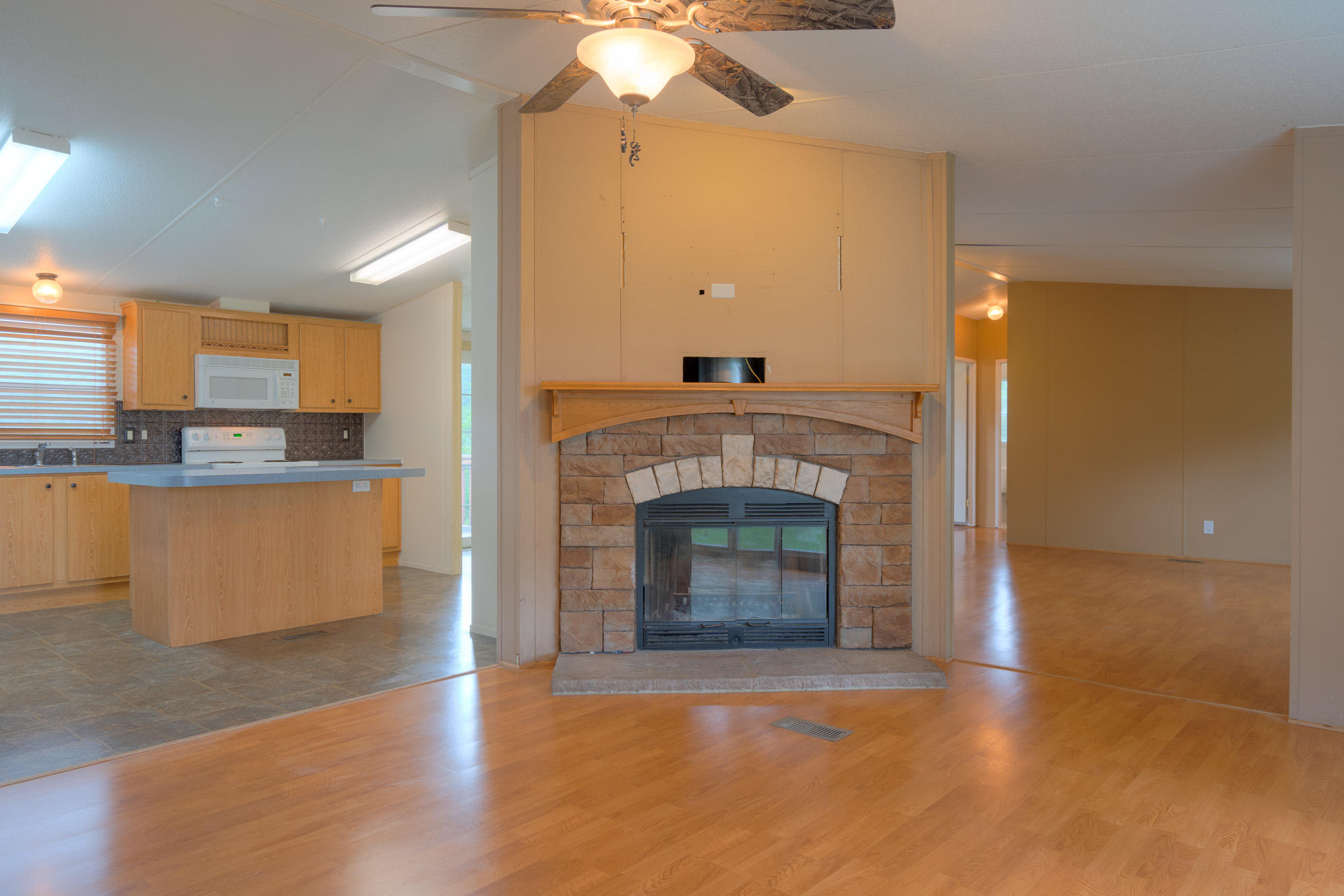 3240 Dallas Freeman Road Hiwassee, VA 24347 - Photo 5 of 42 a view of a kitchen with a fireplace and cabinets