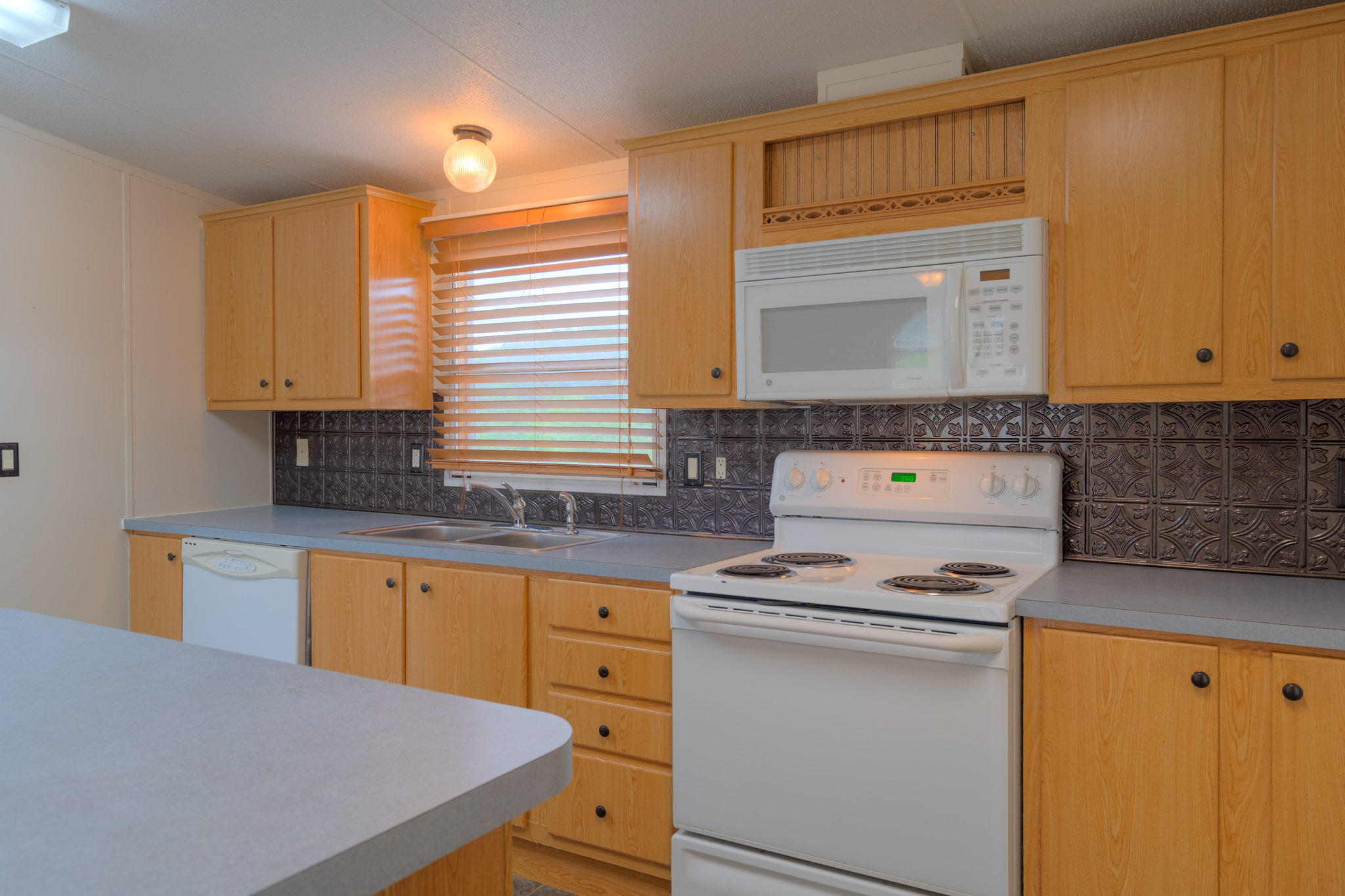 3240 Dallas Freeman Road Hiwassee, VA 24347 - Photo 9 of 42 a kitchen with stainless steel appliances a stove sink and cabinets