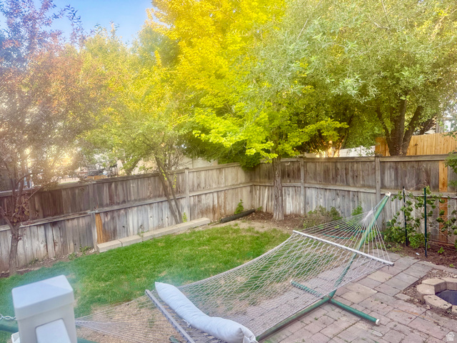 11751 Lake Run Road South Jordan, UT 84009 - Photo 35 of 38 Enclosed backyard featuring a manicured lawn, established trees, and wood fencing