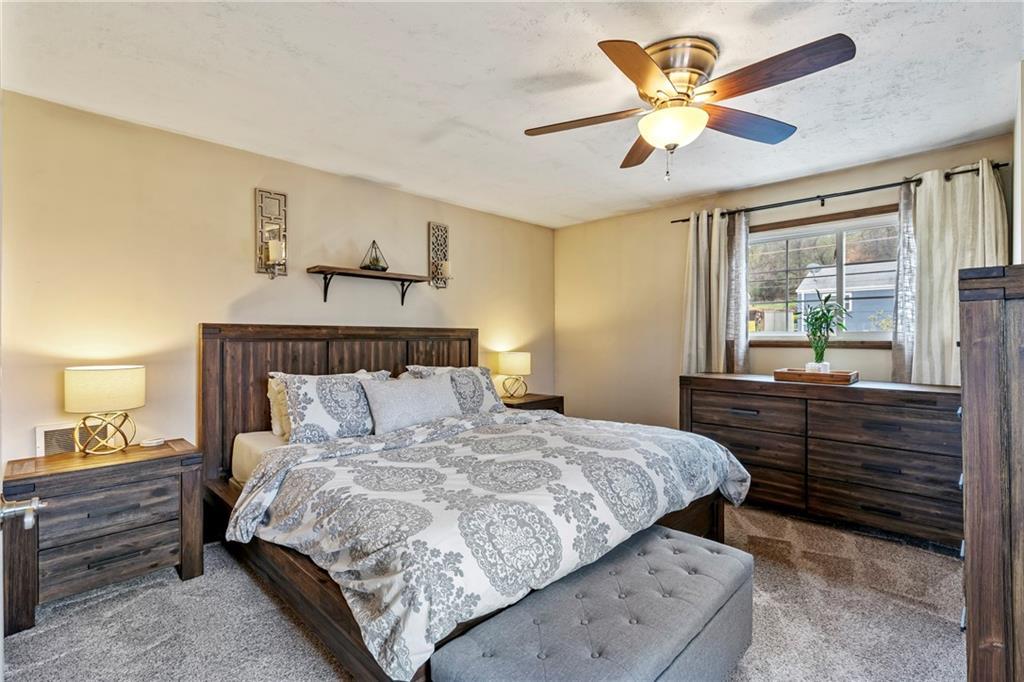 459 East Garden Road Pittsburgh, PA 15227 - Photo 18 of 35 a bedroom with a large bed and a chandelier