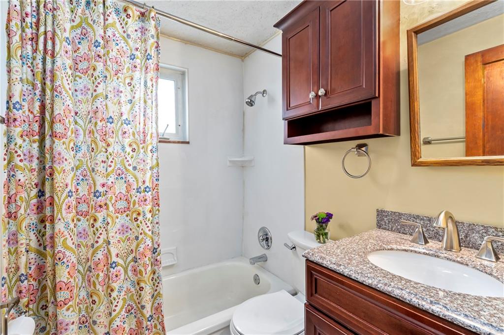 459 East Garden Road Pittsburgh, PA 15227 - Photo 23 of 35 a bathroom with a granite countertop sink toilet a mirror and shower