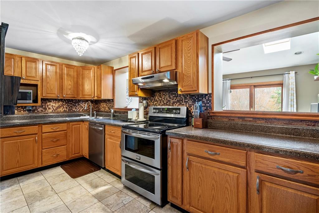 459 East Garden Road Pittsburgh, PA 15227 - Photo 10 of 35 a kitchen with granite countertop a stove sink and cabinets