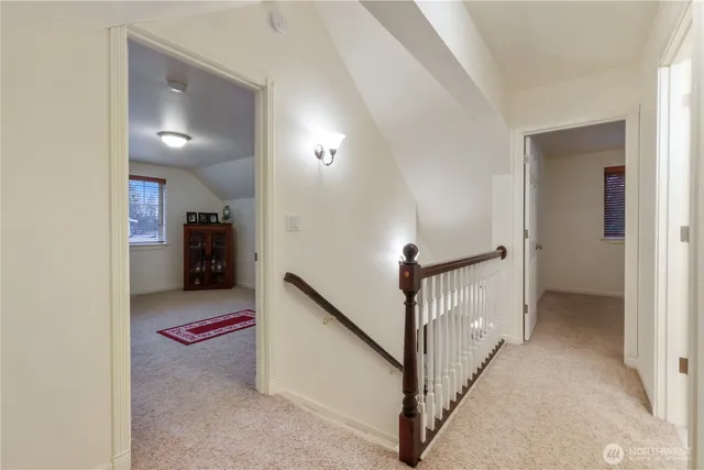 a view of a hallway with a livingroom and entryway