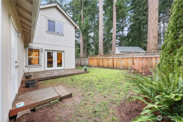a view of a house with backyard and sitting area