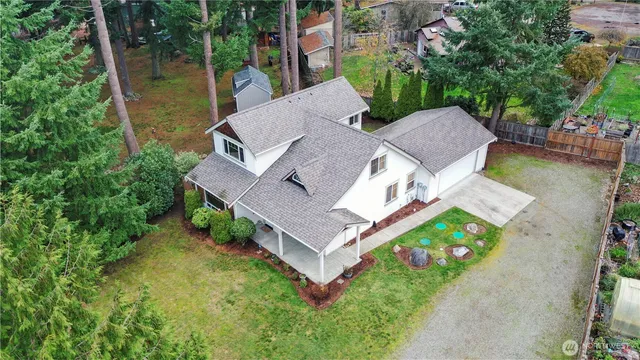 an aerial view of a house with garden space and a house