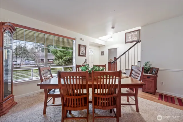 a view of a dining room with furniture window and wooden floor