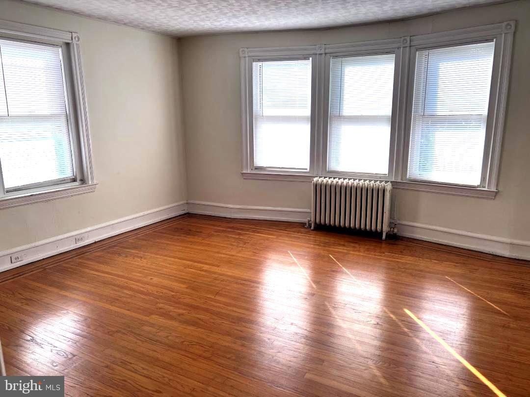 111 Chestnut Avenue Narberth, PA 19072 - Photo 12 of 24 an empty room with wooden floor and windows