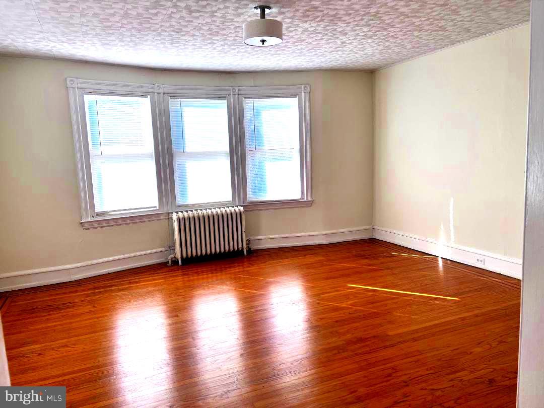 111 Chestnut Avenue Narberth, PA 19072 - Photo 13 of 24 an empty room with wooden floor and windows