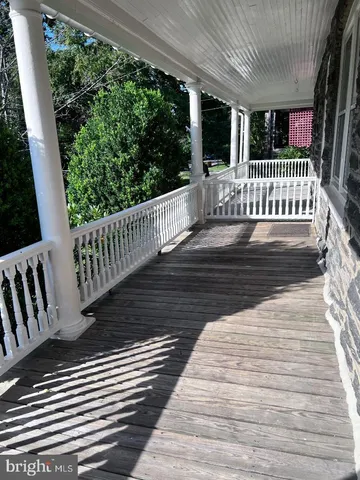 a view of a porch with wooden floor