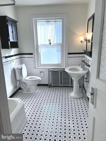 a bathroom with a toilet a sink and a bathtub