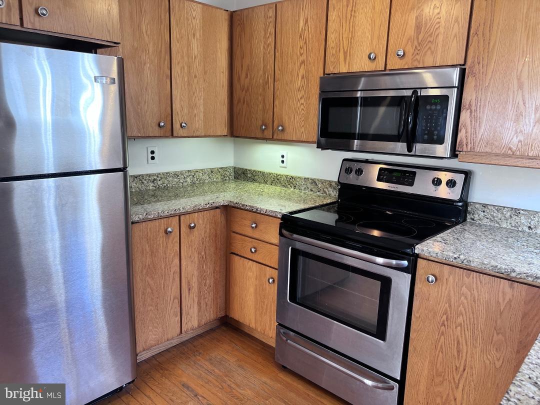 111 Chestnut Avenue Narberth, PA 19072 - Photo 9 of 24 a kitchen with granite countertop a stove microwave and fridge