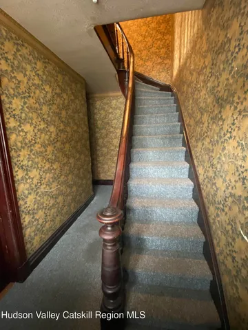 a living room with furniture a window and a chandelier