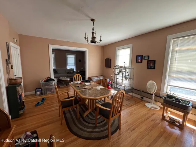 a dining room with furniture and wooden floor