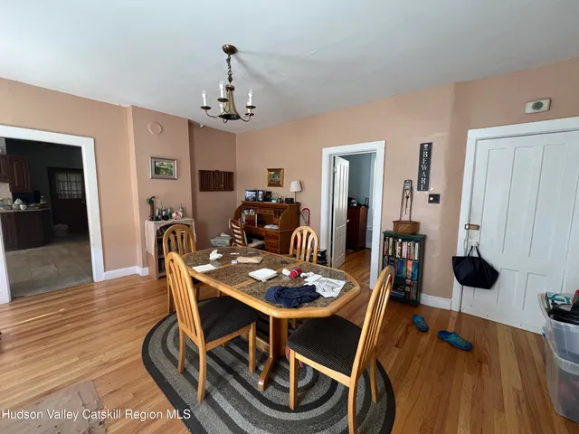 a living room with furniture a flat screen tv and a window