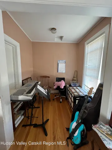 a room with furniture piano and a window